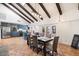 Open concept kitchen and dining area with a large island and wood beams at 7211 E Sunnyside Dr, Scottsdale, AZ 85260