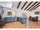 Open concept kitchen with island seating and terracotta floor tiles at 7211 E Sunnyside Dr, Scottsdale, AZ 85260