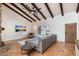 Bright living area with a large sectional sofa and wood beams at 7211 E Sunnyside Dr, Scottsdale, AZ 85260