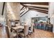 Elegant dining room with stone fireplace and kitchen access at 7211 E Sunnyside Dr, Scottsdale, AZ 85260