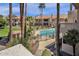 Community swimming pool and spa area with surrounding landscaping and lounge chairs at 930 N Mesa Dr # 2037, Mesa, AZ 85201