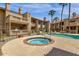 Community hot tub with surrounding patio and building in background at 930 N Mesa Dr # 2037, Mesa, AZ 85201