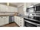 Updated kitchen featuring stainless steel appliances and white cabinetry at 930 N Mesa Dr # 2037, Mesa, AZ 85201
