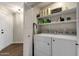 Laundry room with washer, dryer, and storage shelves at 930 N Mesa Dr # 2037, Mesa, AZ 85201