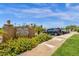 Community entrance sign with landscaping and parking area for residents at 930 N Mesa Dr # 2037, Mesa, AZ 85201