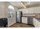 Updated kitchen with white cabinets, stainless steel appliances, and wood flooring at 930 N Mesa Dr # 2037, Mesa, AZ 85201