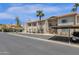 Building exterior with parking spaces, landscaping, and a covered carport at 930 N Mesa Dr # 2037, Mesa, AZ 85201