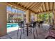 Relaxing poolside patio area with tables and chairs under covered seating at 930 N Mesa Dr # 2037, Mesa, AZ 85201