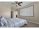 Bedroom with striped bedding, ceiling fan, and projector screen at 930 N Mesa Dr # 2037, Mesa, AZ 85201