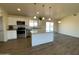 Open concept kitchen with island, looking toward dining area at 13419 S Hermit Rd, Buckeye, AZ 85326