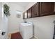 Bright laundry room with white washer and dryer, and dark brown cabinets at 6202 E Mckellips Rd # 310, Mesa, AZ 85215