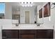 Double vanity with dark wood cabinets in bathroom at 6202 E Mckellips Rd # 310, Mesa, AZ 85215