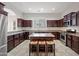 Spacious kitchen with dark wood cabinets, granite counters and island with seating at 6202 E Mckellips Rd # 310, Mesa, AZ 85215