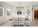 Charming dining room with a rustic wooden table and white chairs at 6202 E Mckellips Rd # 310, Mesa, AZ 85215
