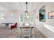 Bright dining area featuring a wooden table, white chairs, and kitchen access at 6202 E Mckellips Rd # 310, Mesa, AZ 85215