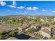 Aerial view of community with houses near golf course and mountains at 6202 E Mckellips Rd # 310, Mesa, AZ 85215