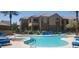 Community pool with blue lounge chairs and building view in background at 7027 N Scottsdale Rd # 237, Scottsdale, AZ 85253
