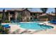 Freeform community pool with blue lounge chairs at 7027 N Scottsdale Rd # 237, Scottsdale, AZ 85253