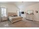 Bright bedroom featuring a king-size bed and built-in dresser at 13355 N 100Th Pl, Scottsdale, AZ 85260