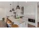Modern kitchen with white cabinets, granite island, and stainless steel appliances at 6166 N Scottsdale Rd # C3006, Paradise Valley, AZ 85253