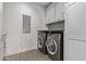 Bright laundry room with modern washer and dryer, ample storage and tile flooring at 6166 N Scottsdale Rd # C3006, Paradise Valley, AZ 85253