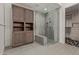 Modern bathroom with glass shower, built-in shelving, and stylish tile at 6166 N Scottsdale Rd # C3006, Paradise Valley, AZ 85253