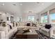 Living room with sectional sofa, city view, and hardwood floors at 6166 N Scottsdale Rd # C3006, Paradise Valley, AZ 85253