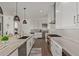 Modern kitchen with white cabinets, granite island, and stainless steel appliances at 6166 N Scottsdale Rd # C3006, Paradise Valley, AZ 85253
