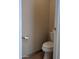Small half bathroom with toilet and a wall mounted toilet paper holder at 15151 N 100Th Way, Scottsdale, AZ 85260