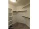 Spacious walk-in closet with shelves and hanging rods at 15151 N 100Th Way, Scottsdale, AZ 85260