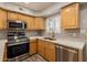 Modern kitchen with stainless steel appliances and updated cabinetry at 1425 E Desert Cove Ave # 43, Phoenix, AZ 85020