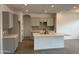 Modern kitchen with an island, gray cabinets, and tile flooring at 24066 N 162Nd Ln, Surprise, AZ 85387