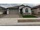 Two-car garage with neutral-toned exterior and artificial turf at 24066 N 162Nd Ln, Surprise, AZ 85387