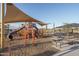 Modern playground equipment under shade structures at 24066 N 162Nd Ln, Surprise, AZ 85387