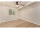 Bright bedroom with light wood floors and a ceiling fan at 6325 E Monte Cristo Ave, Scottsdale, AZ 85254