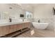 Modern bathroom with double vanity, soaking tub, and marble accents at 6325 E Monte Cristo Ave, Scottsdale, AZ 85254