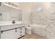 Modern bathroom with white vanity, marble tile, and soaking tub at 6325 E Monte Cristo Ave, Scottsdale, AZ 85254