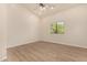 Bright bedroom with ceiling fan, large closet, and wood-look flooring at 6325 E Monte Cristo Ave, Scottsdale, AZ 85254