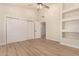 Spacious bedroom with built-in shelving and wood-look flooring at 6325 E Monte Cristo Ave, Scottsdale, AZ 85254