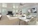 Open living room and dining area with a modern fireplace and large windows at 6325 E Monte Cristo Ave, Scottsdale, AZ 85254