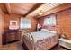 Bedroom with antique iron bed frame and wood floors at 1310 Kenrick Dr, Wickenburg, AZ 85390