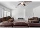 Living room with brown leather furniture and ceiling fan at 1818 W Thomas Rd, Phoenix, AZ 85015