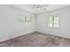 Spacious bedroom with ceiling fan, carpet, and large window at 1818 W Thomas Rd, Phoenix, AZ 85015