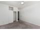 Bedroom with ceiling fan, carpet, and built-in shelving at 1818 W Thomas Rd, Phoenix, AZ 85015