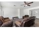Bright living room featuring brown leather reclining sofas and a ceiling fan at 1818 W Thomas Rd, Phoenix, AZ 85015