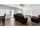 Living room with brown leather furniture and ceiling fan at 1818 W Thomas Rd, Phoenix, AZ 85015
