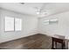 Bright bedroom with ceiling fan and dark brown nightstand at 1818 W Thomas Rd, Phoenix, AZ 85015
