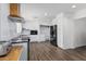Modern kitchen with white cabinets, black appliances, and wood countertop at 1818 W Thomas Rd, Phoenix, AZ 85015