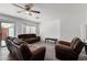 Living room with brown leather furniture and ceiling fan at 1818 W Thomas Rd, Phoenix, AZ 85015