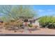 An inviting home exterior featuring a stone facade, wooden door, and lush landscaping at 8006 S 38Th Pl, Phoenix, AZ 85042